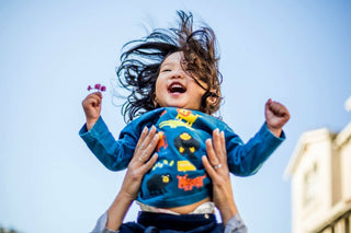 Happy toddler getting lifted in the air