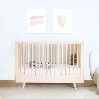 Toddler sleeping on stomach in Natural Lola Crib