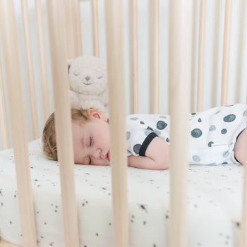 Toddler sleeping on stomach in DreamBreeZzz Breathable Crib Mattress