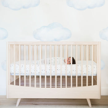 Baby lying awake in Natural Lola Crib