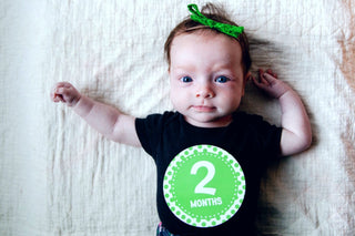 Baby wearing "2-month" bodysuit