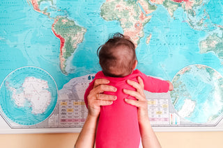 place baby names - infant looking at world map