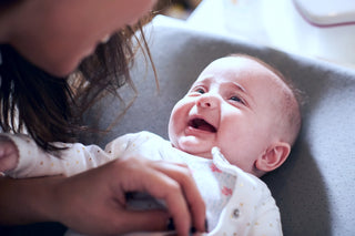 12-week-old baby laughs as her mom tickles her belly