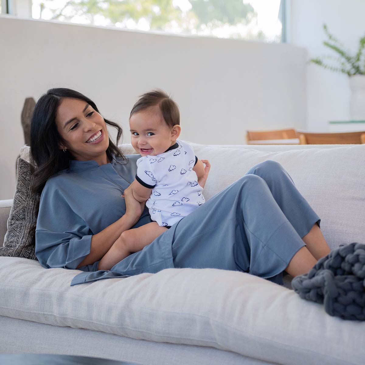 mother with child sitting down in lounge set attire