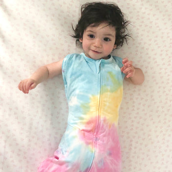 Baby in Rainbow Tie-Dye Sleepea with arms out