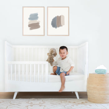 Boy getting out of white Lola Crib toddler bed