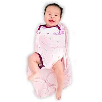 Baby in unzipped rose planets Sleepea swaddle sack