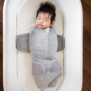 Baby sleeping in Graphite Stars SNOO Sack on Ivory SNOO Sheet in SNOO