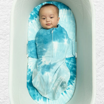 Baby swaddled in Blue Tie-Dye SNOO Sack in SNOO